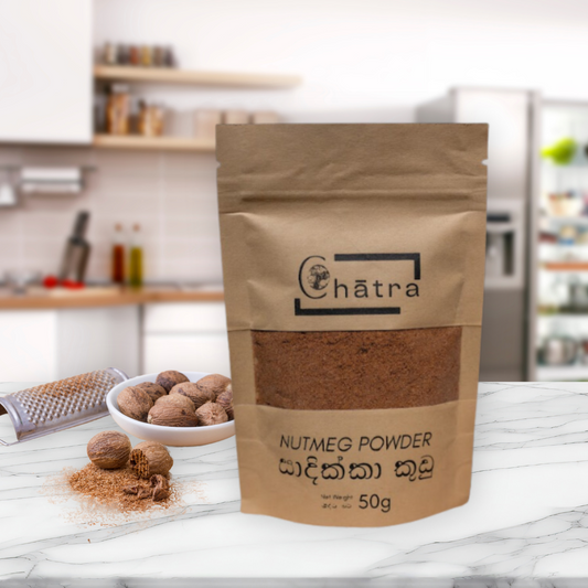 Ceylon Organic House Nutmeg powder pack sitting on a kitchen countertop with nutmeg nearby